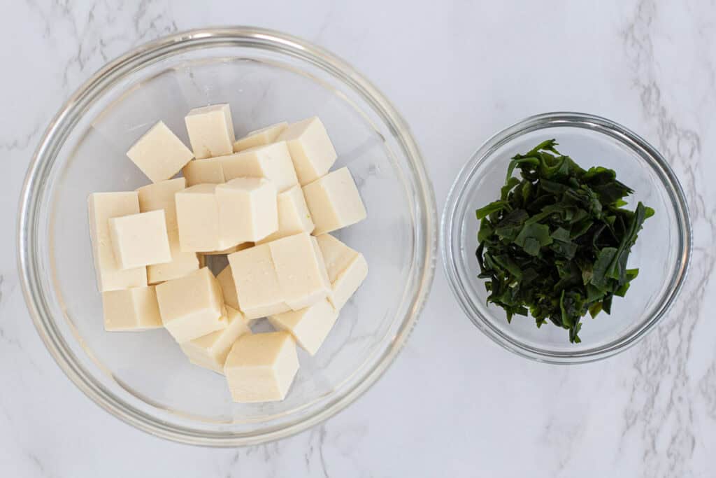 Cubed silken tofu and prepared wakame seaweed ready to be added to miso soup