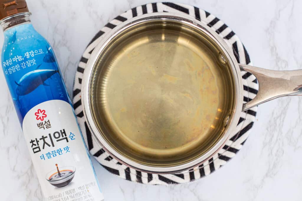 Dashi heating gently in a saucepan as the base for miso soup