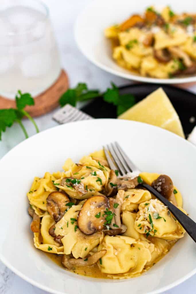 Plated creamy miso mushroom pasta with tortellini served for a cozy dinner