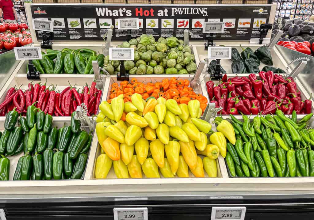 Colorful loose peppers and vegetables at grocery store display showing flexible shopping for small households