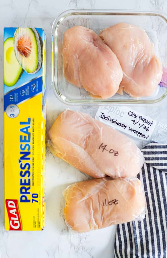 Chicken breasts portioned and individually wrapped to show how to divide family packs when grocery shopping for two