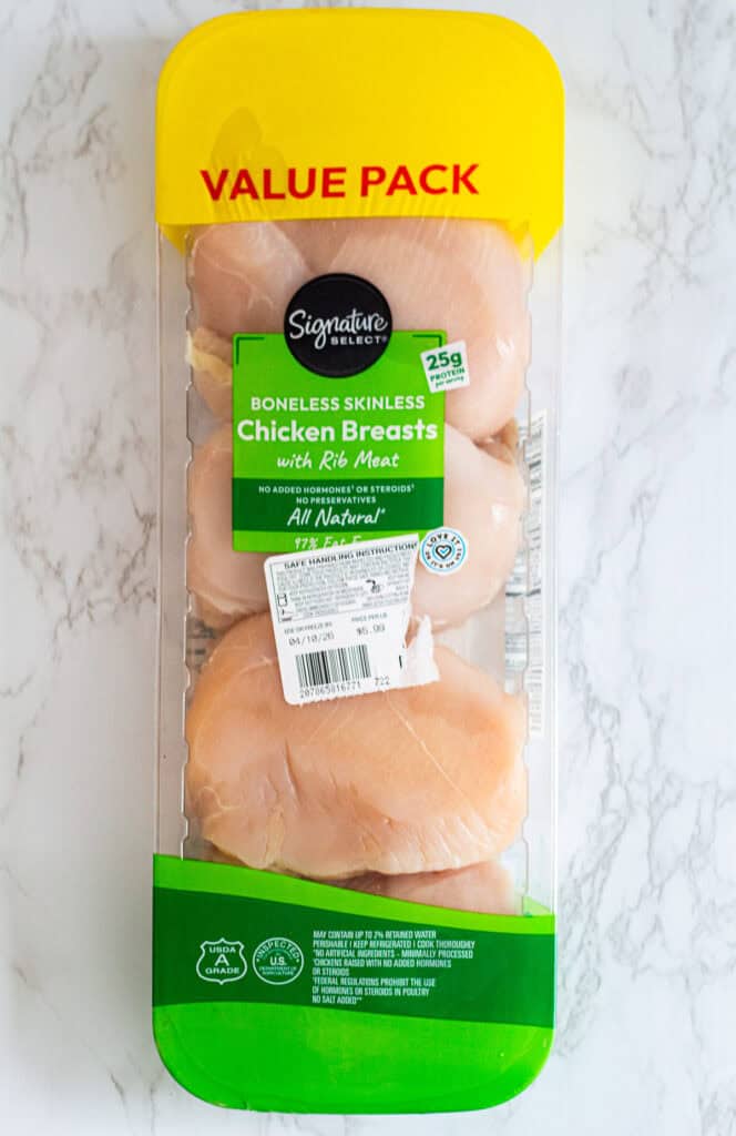 Large family pack of chicken breast showing bulk purchase before portioning for cooking for two