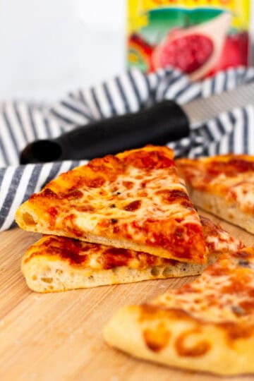 Slice of homemade cheese pizza made with sourdough discard pizza dough