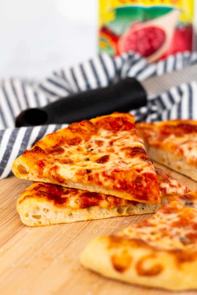 Slice of homemade cheese pizza made with sourdough discard pizza dough
