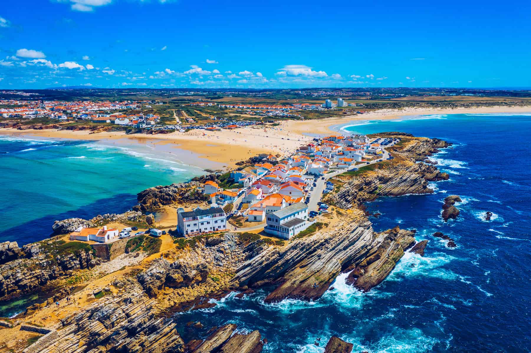 Aerial view of island Baleal naer Peniche on the shore of the ocean in west coast of Portugal. Baleal Portugal with incredible beach and surfers. Aerial view of Baleal, Portugal.