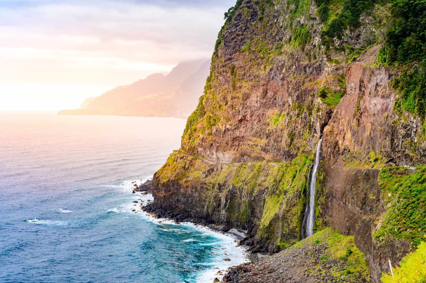 Beautiful wild coast scenery view with Bridal Veil Falls (Veu da noiva) at Ponta do Poiso in Madeira Island. Near Porto Moniz, Seixal, Portugal.