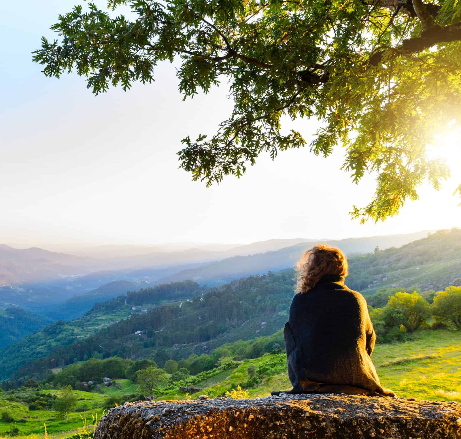 scenic view of woman watching at sunset mountains, Peneda-Geres National Park, northern Portugal.