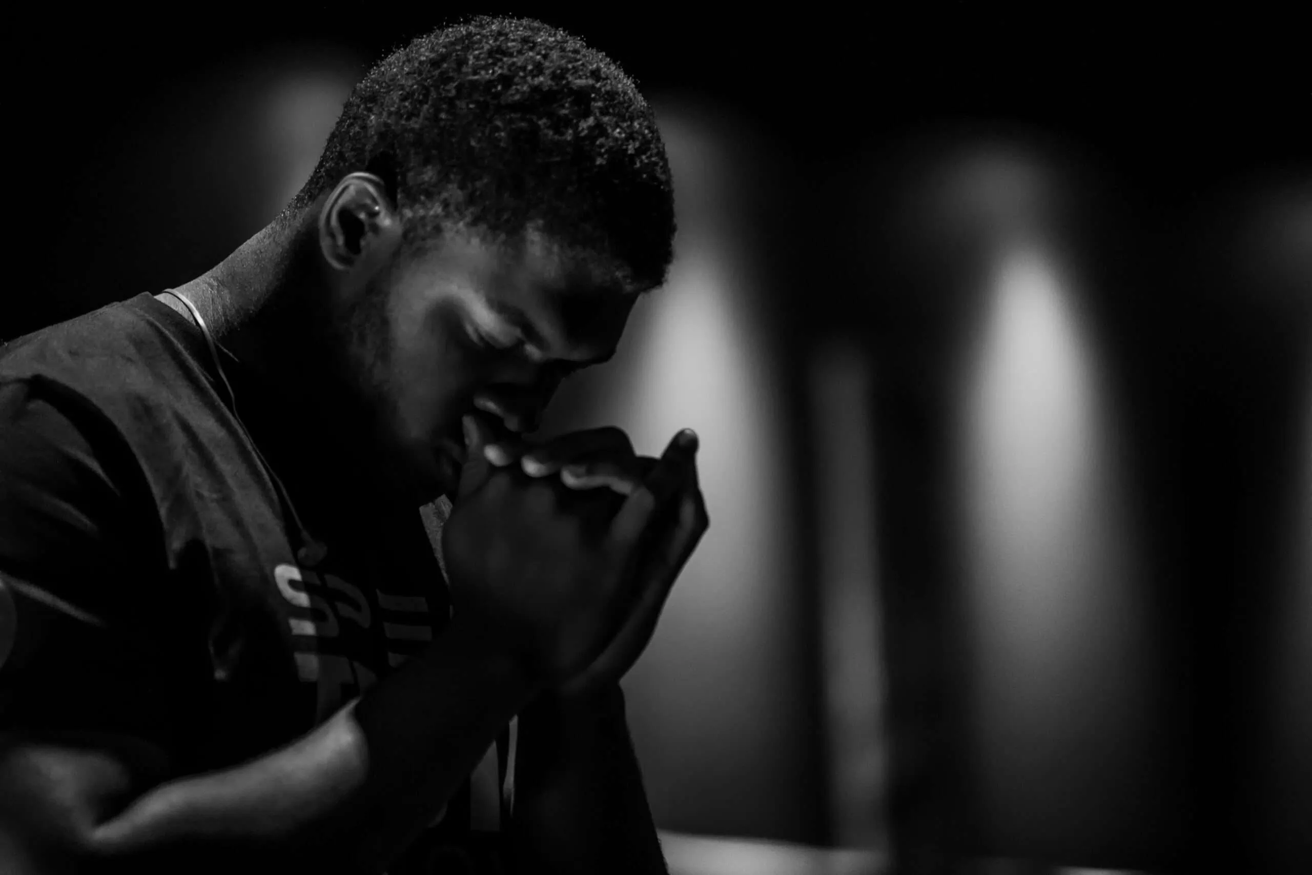 A worshiper praying during a Next Level Worship gathering