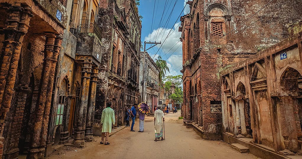 OLD STREETSCAPE WITH ANCIENT BUILDINGS AND WORSHIPPERS, CULTURAL FESTIVAL SCENE.