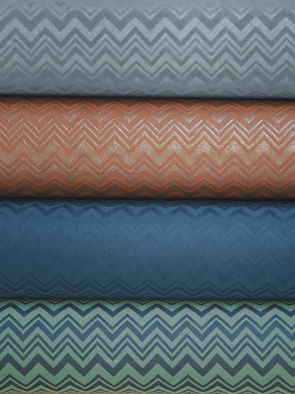 Colorful chevron patterned fabric rolls for upholstery, curtains, and home decor projects.