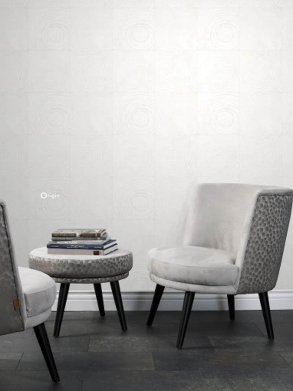Elegant white lounge chairs with patterned backrests and matching ottoman in a contemporary setting.