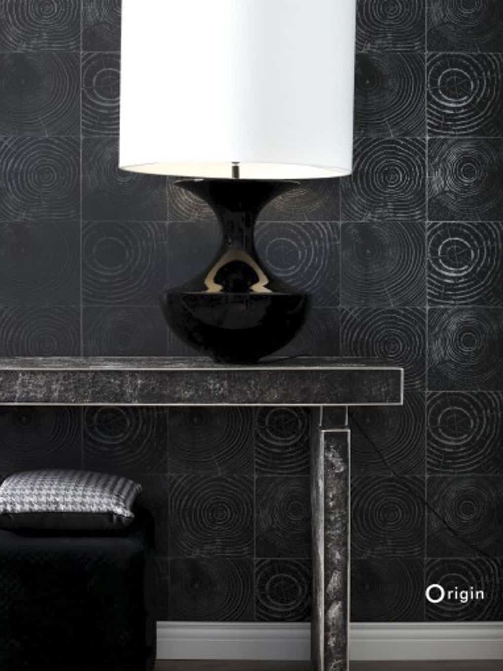 Contemporary black and white table lamp on a sleek black table.