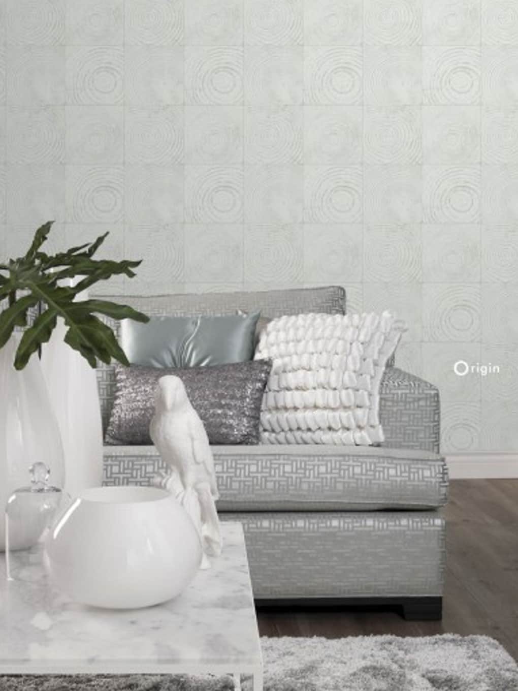 Contemporary living room with textured wall, sofa, and decorative pillows.