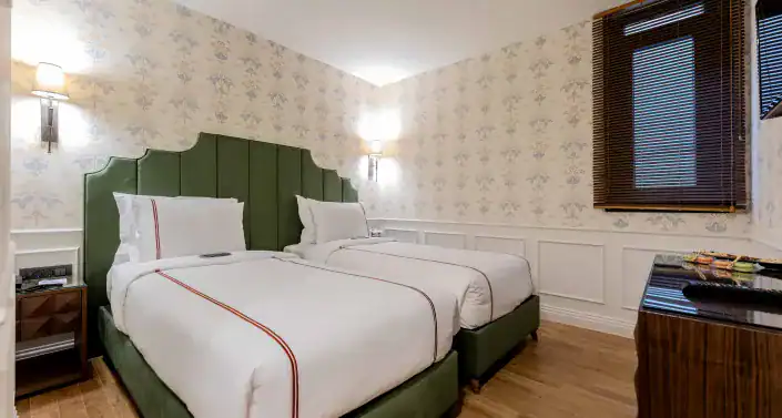 Elegant hotel room at Khai Hotel Karaköy with stylish decor and comfortable beds.