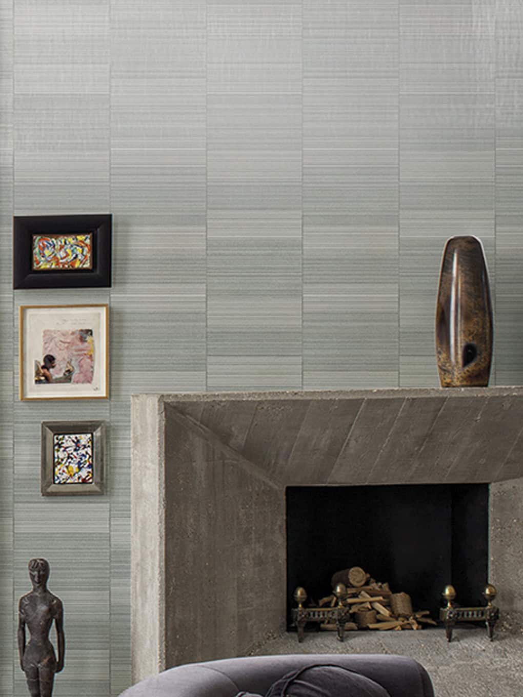 Contemporary interior design featuring textured gray wall, framed artwork, and stylish decor accents.