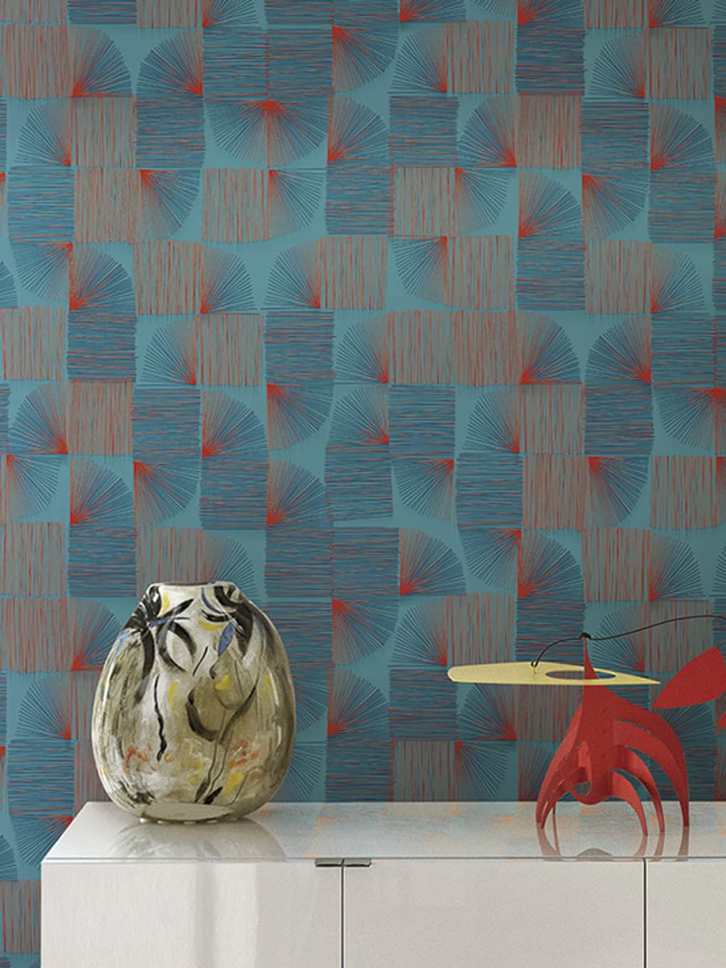 Vibrant geometric patterned wall with decorative vase and sculpture on white console table.