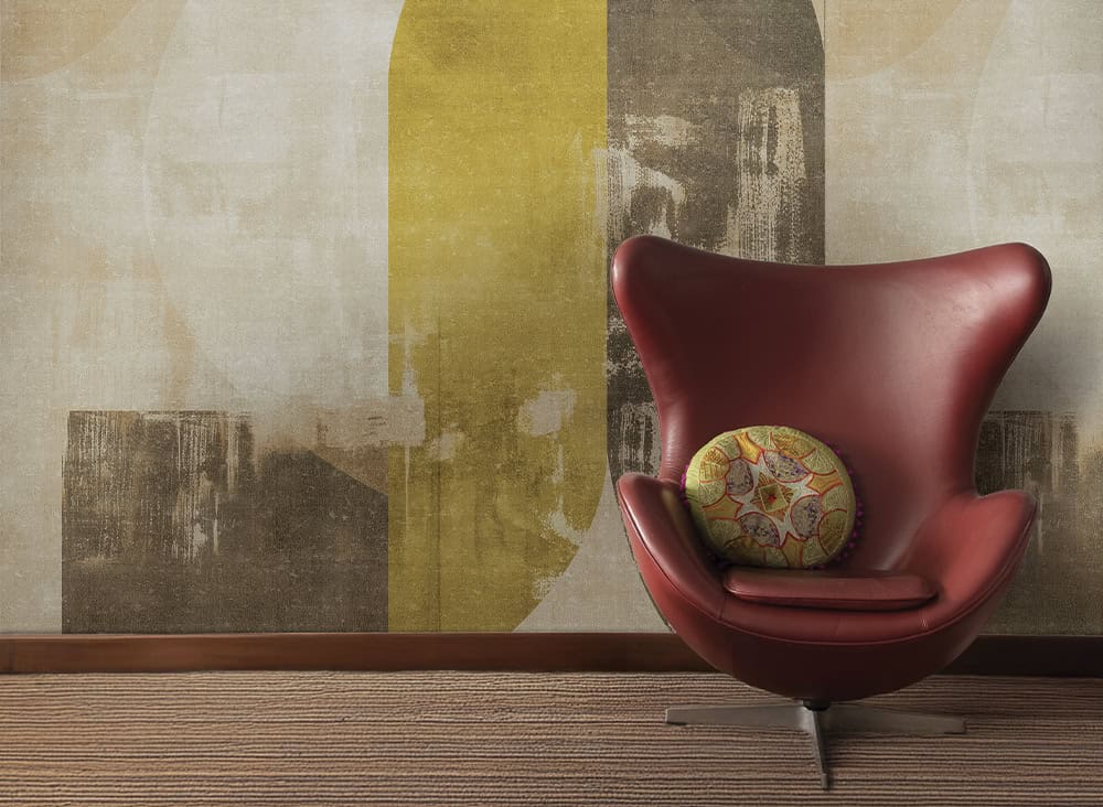 Modern red lounge chair with decorative cushion in stylish interior setting.