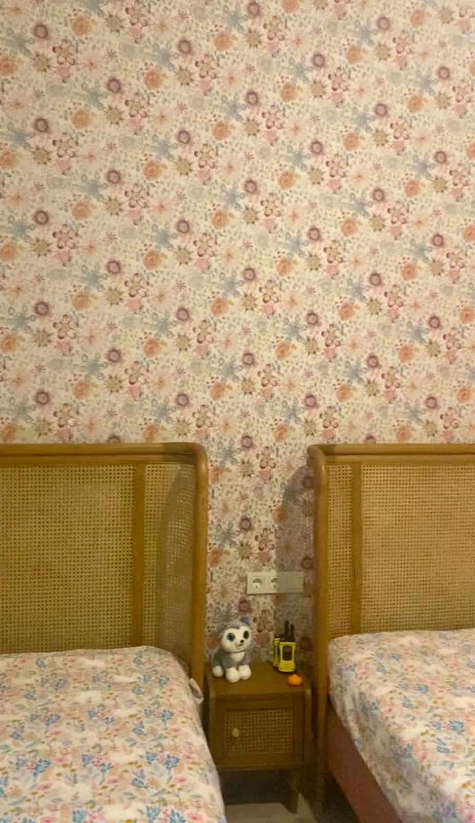 Cozy bedroom with floral wallpaper and wooden headboards at Eco Farm Villas Gümüşlük Bodrum.