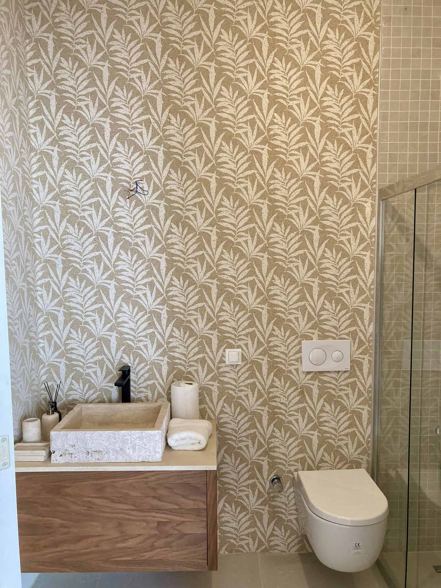 Elegant bathroom with botanical wallpaper, sink, and toilet in ECO FARM VİLLALARI GÜMÜŞLÜK BODRUM.