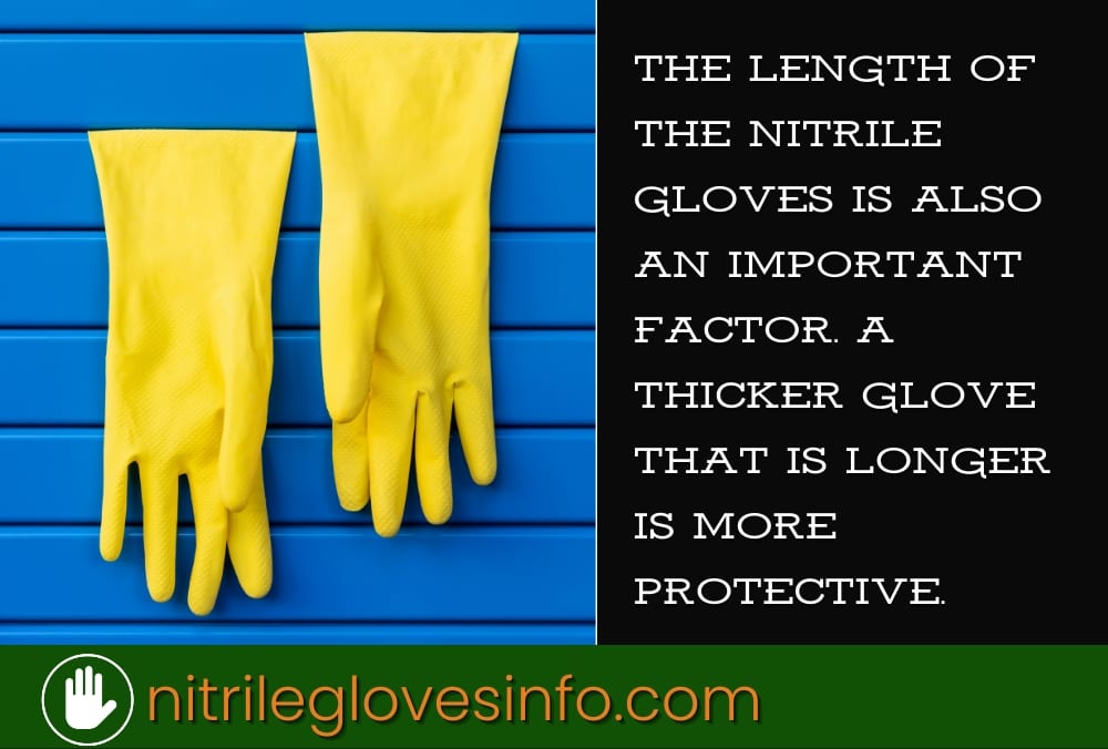 Two yellow nitrile gloves hanging on a blue wall. Longer gloves offer better protection.