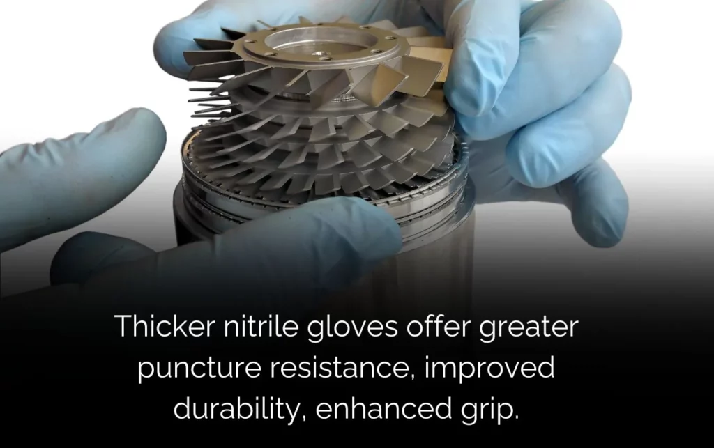 Hands in thick nitrile gloves carefully handling precision turbine blades. Greater puncture resistance and enhanced grip.
