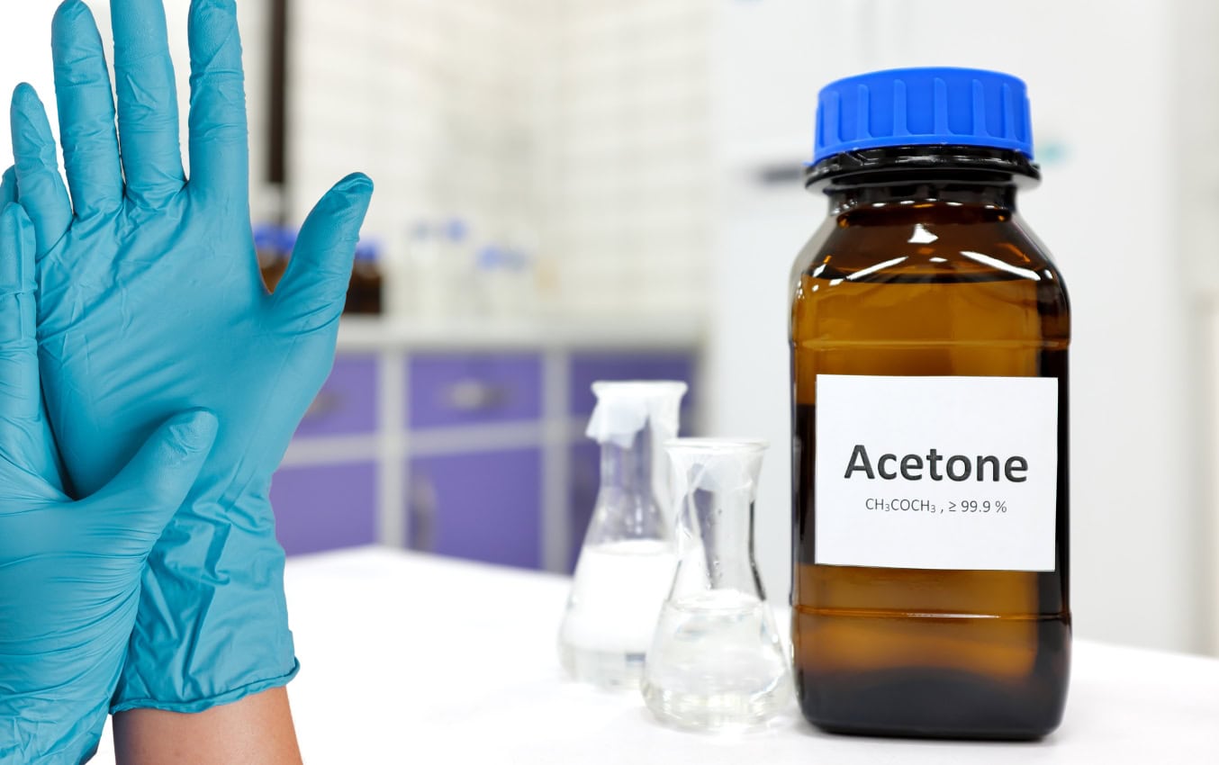 Acetone bottle and nitrile gloves; chemical permeation test.
