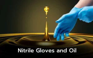 Blue nitrile gloves near oil droplet; demonstrating oil resistance.