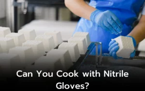 Person wearing blue nitrile gloves handles blocks of cheese. Can you cook with nitrile gloves?