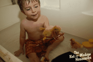 Our New Ducklings | The Not so Modern Housewife boy playing in bathtub with baby ducklings