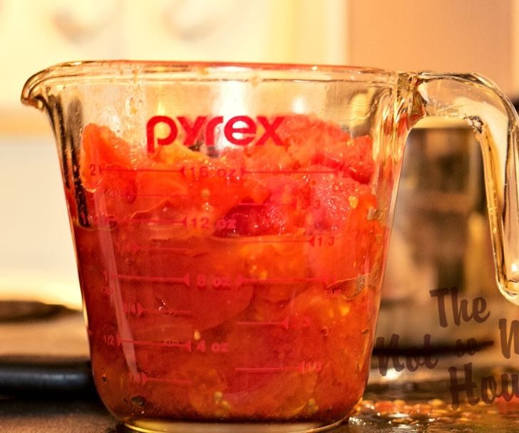 Delicious Restaurant Style Homemade Salsa Recipe with 4 Tips for Water Bath Canning | The Not so Modern Housewife Glass measuring jar with diced tomatoes for homemade salsa recipe