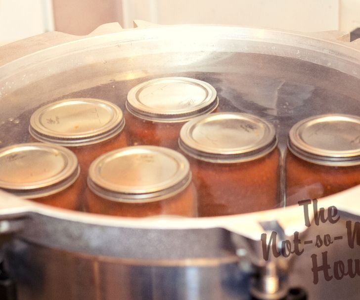 Delicious Restaurant Style Homemade Salsa Recipe with 4 Tips for Water Bath Canning | The Not so Modern Housewife jars of homemade salsa processing in water bath canning
