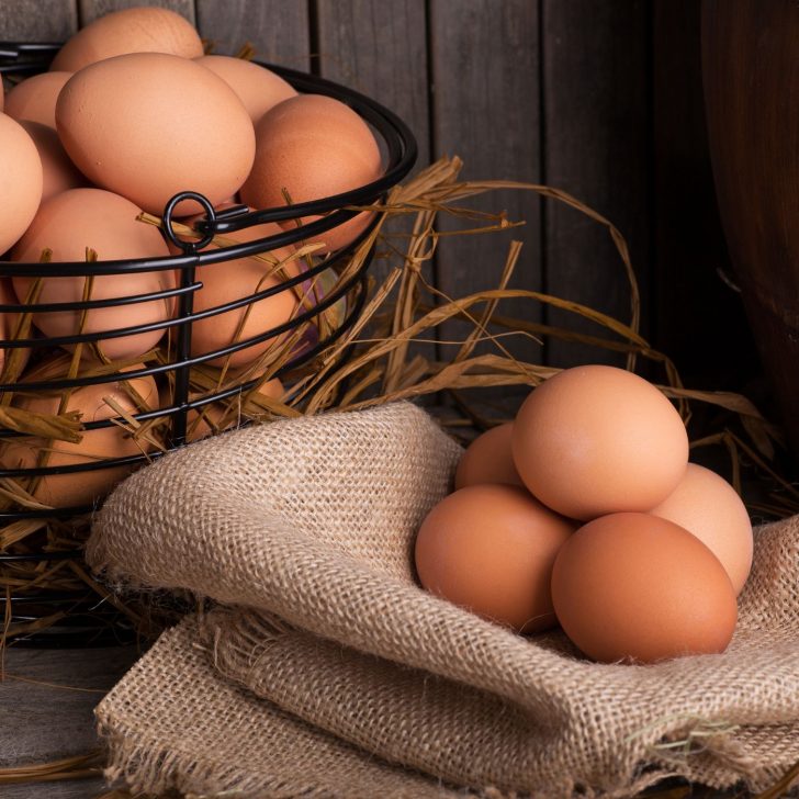 The Ultimate Guide: 12 Steps to Raising Backyard Chickens for Eggs | The Not so Modern Housewife brown eggs on burlap and in black wire egg basket - learn about egg-laying - raising backyard chickens