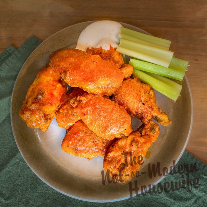 How to Make Delicious Cast Iron Chicken Wings at Home for a Fraction of the Cost | The Not so Modern Housewife Cast Iron Chicken Wings with ranch dressing and celery sticks