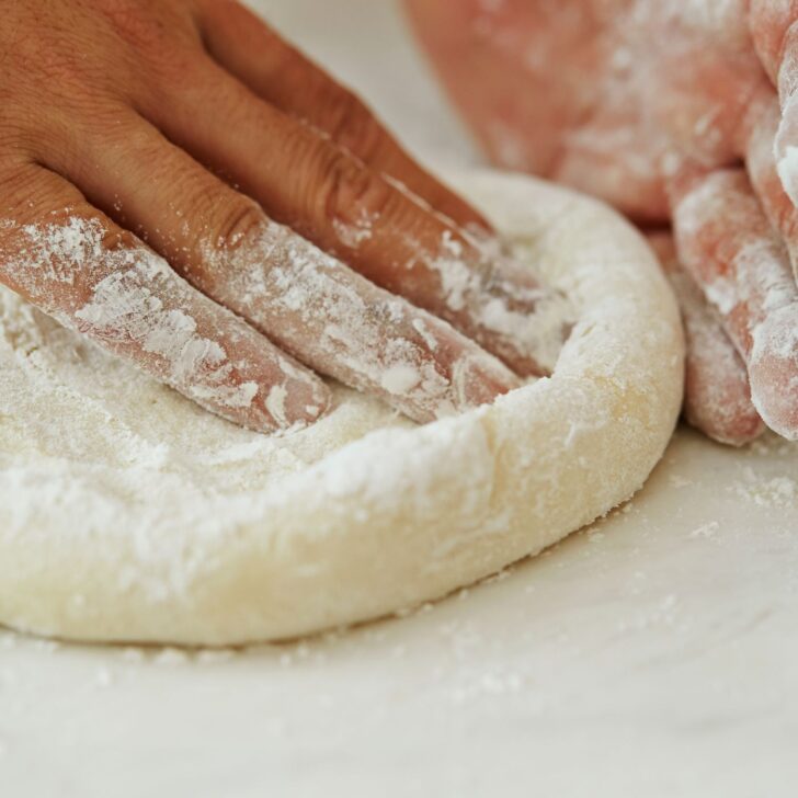 Master the Art of Pizza: Simple Steps to Perfect Easy Pizza Dough | The Not so Modern Housewife using fingers to press out and shape easy pizza dough
