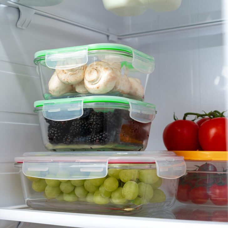 Understanding and Managing Estrogen Dominance Naturally | The Not so Modern Housewife glass containers for food storage with grapes, blackberries, and mushrooms - red tomatoes are in the background - reduce plastic use to help with estrogen dominance