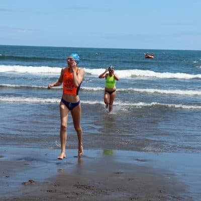 Beach swimmers enjoying the waves at New Plymouth, New Zealand.