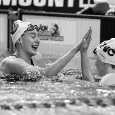 High-fiving female swim team after training at New Plymouth Physiotherapy pool in NZ.