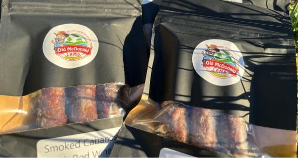 Brag worthy lamb jerky Showing two black vacuum-sealed packs of lamb jerky with Old McDonald Lamb branding on the labels.