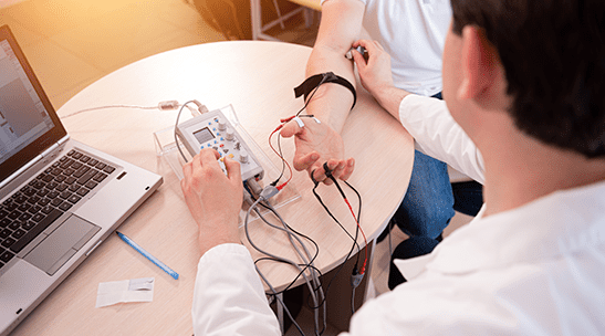 EMG Doctor assisting patient with testing