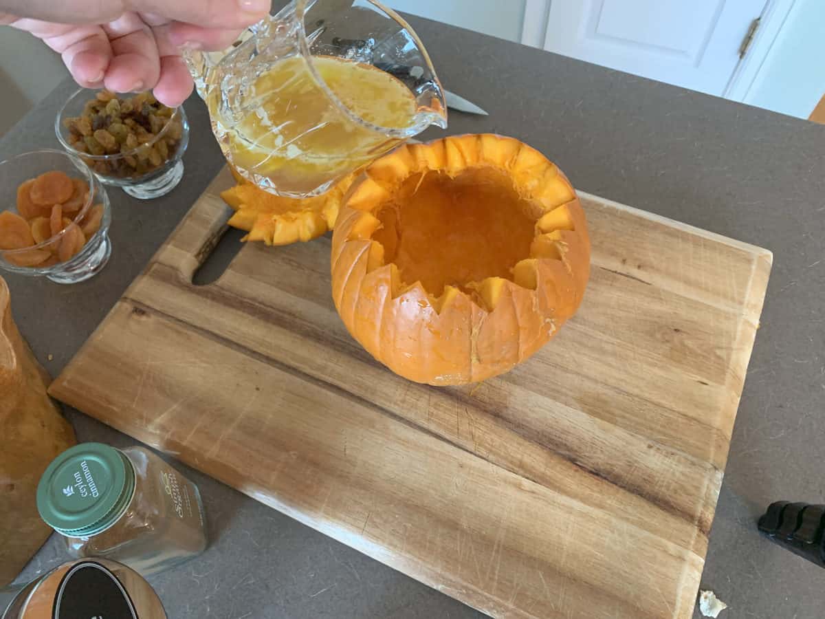 Pouring the clarified putter into th pumpkin.