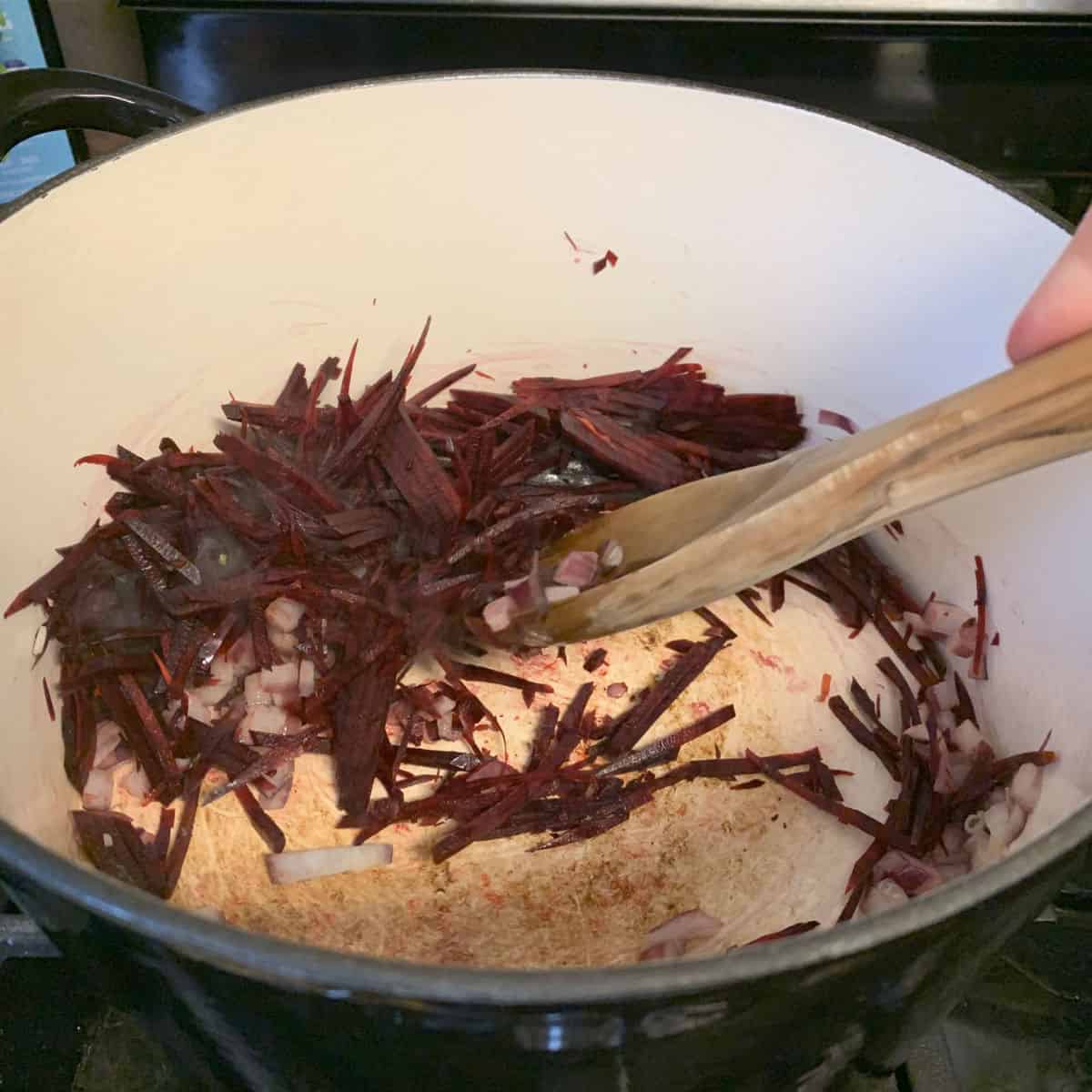 Sautéing the beets in a dutch oven.