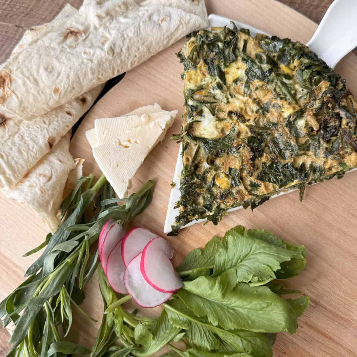 Piece of fried eggs with lavash and cheese.