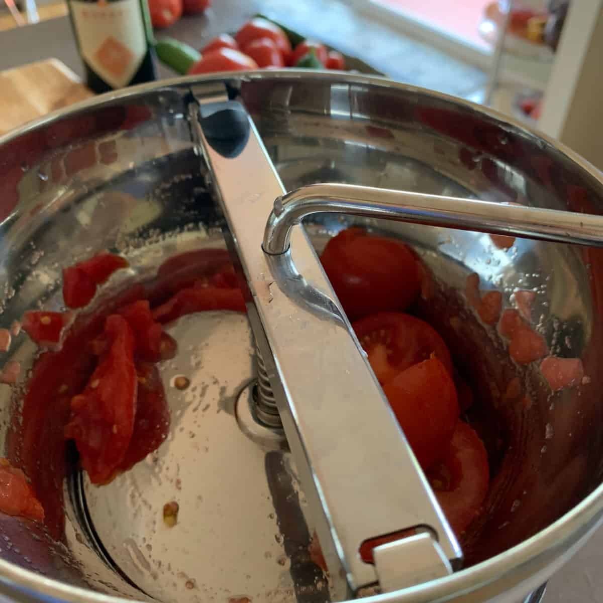 Processing tomatoes through a food mill.