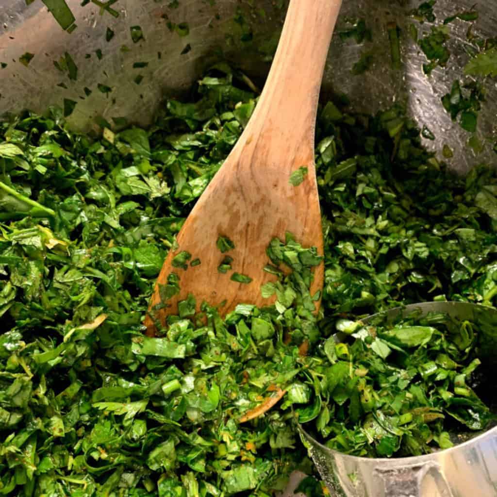 A large bowl of finely chiffonaded mixed greens and herbs — the filling for Jingalov Hats — including spinach, purslane, chervil, and sorrel.
