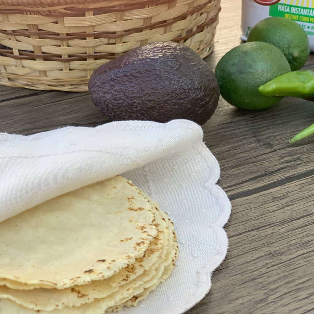 Homemade corn tortilla wrapped in a serviette.