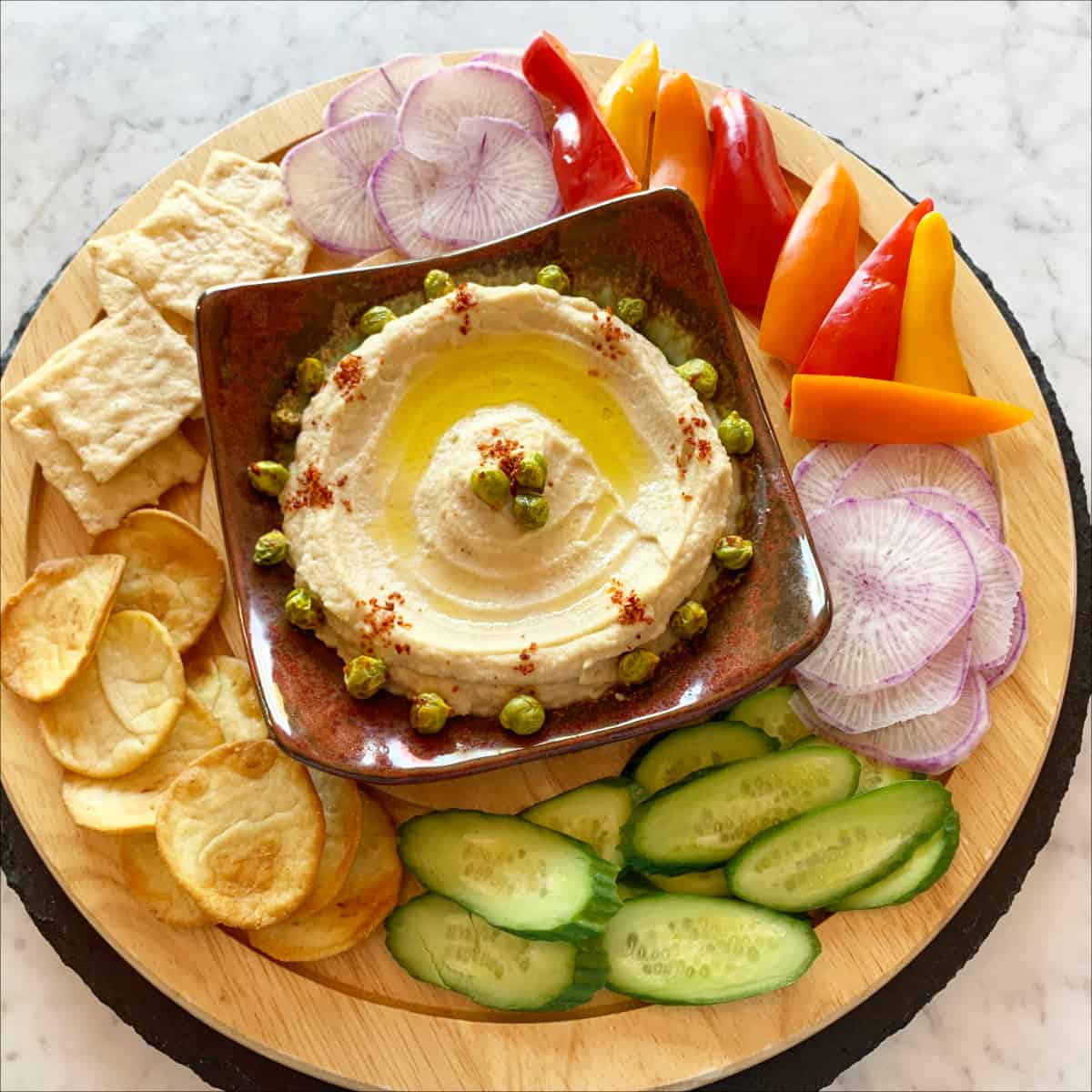 Authentic Hummus with vegetables and pita chips.