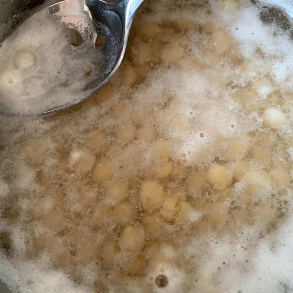 Scooping the foam while chickpeas are cooking