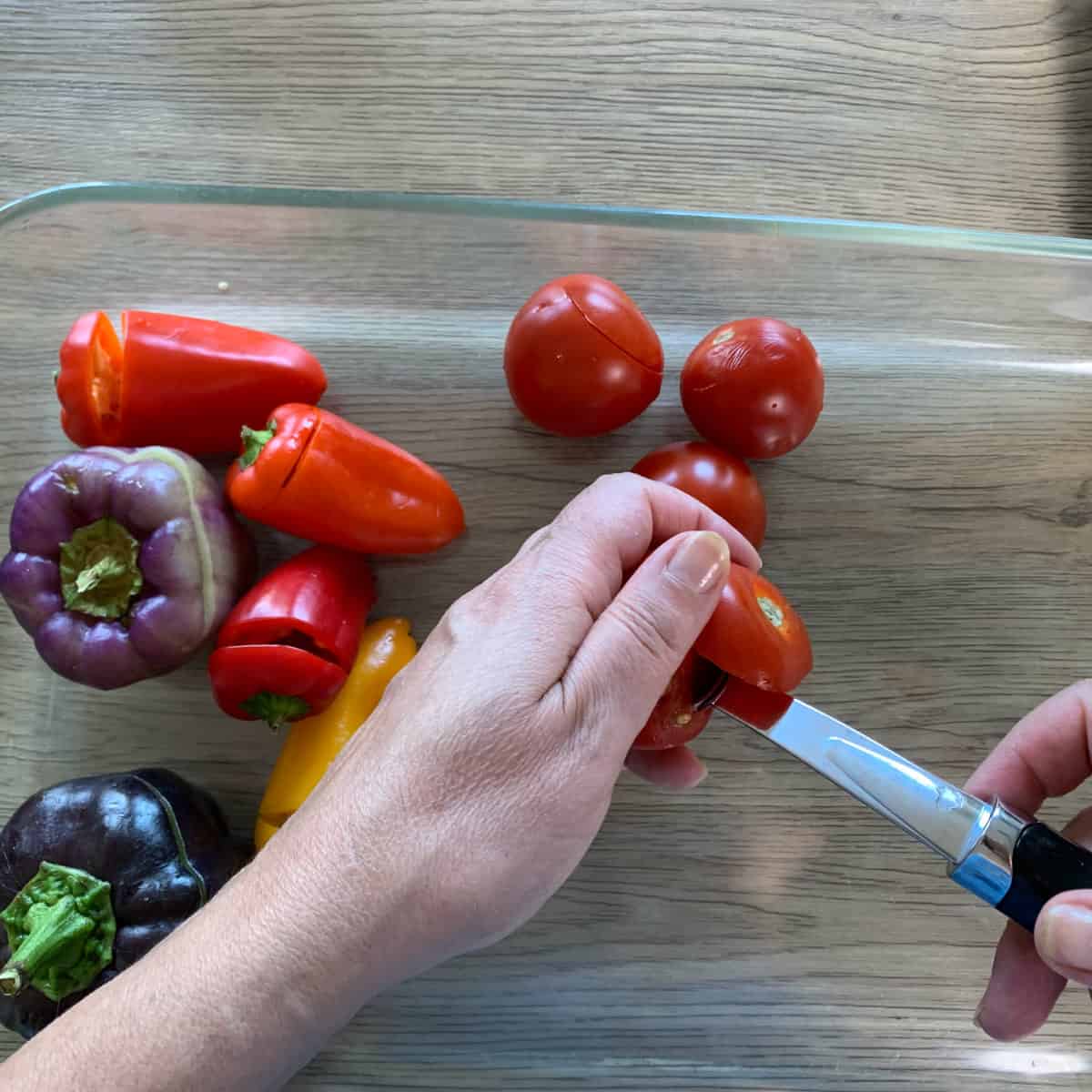 Coring the tomatoes with a melon baller.