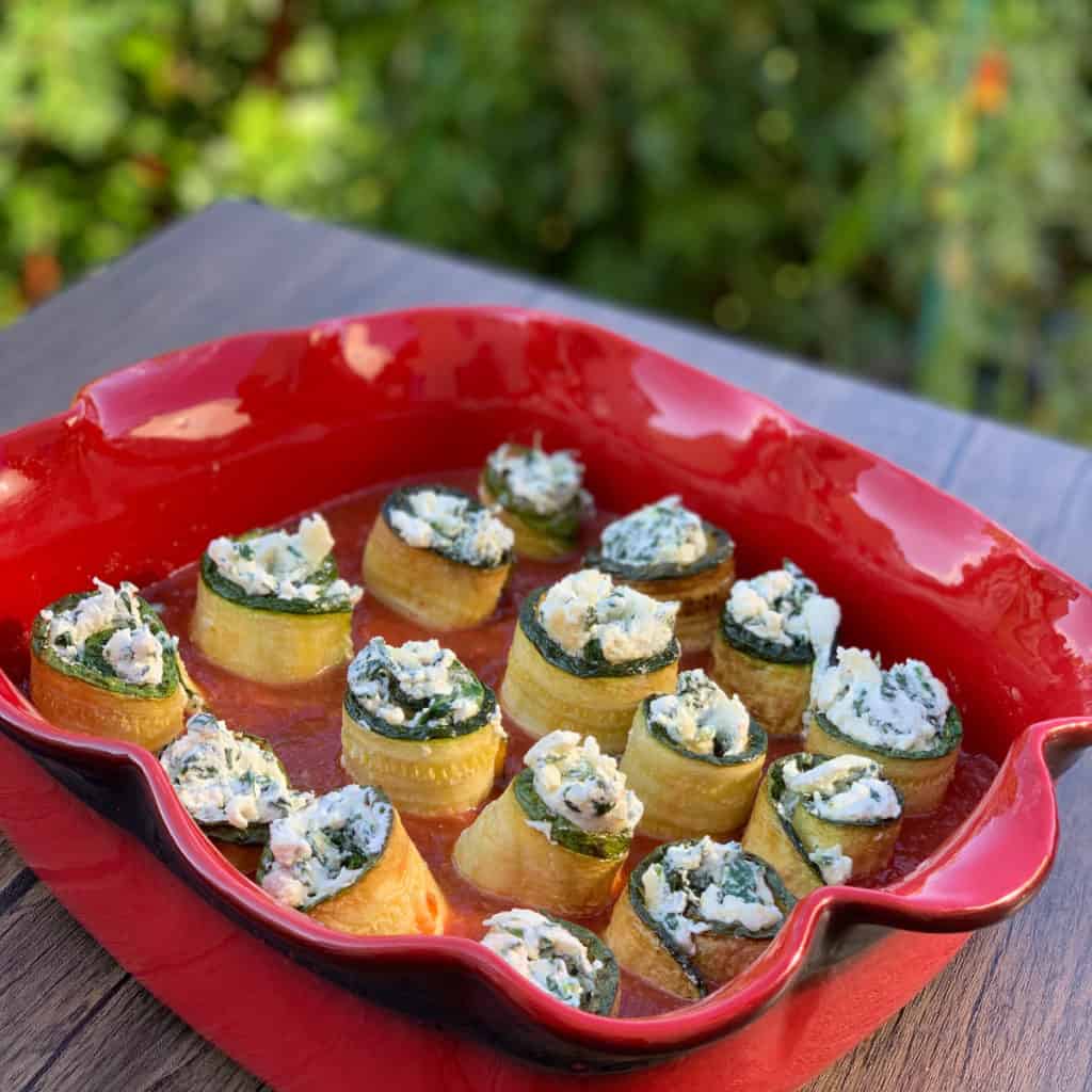 Zucchini roll-ups in a baking dish.