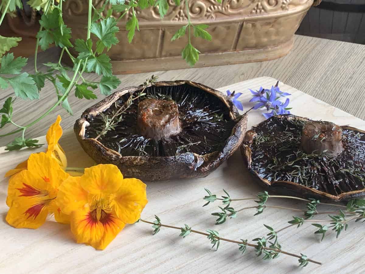 Smoked portobello mushroom ready to eat on a cutting board.